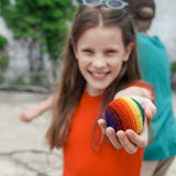girl holding out hacky sack